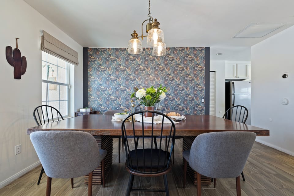 Stylish dining space with a bold cosmic-inspired feature wall.