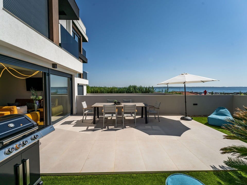 Sky, Building, Shade, Plant, Table, Outdoor Furniture, Grass, Urban Design, Leisure, Residential Area