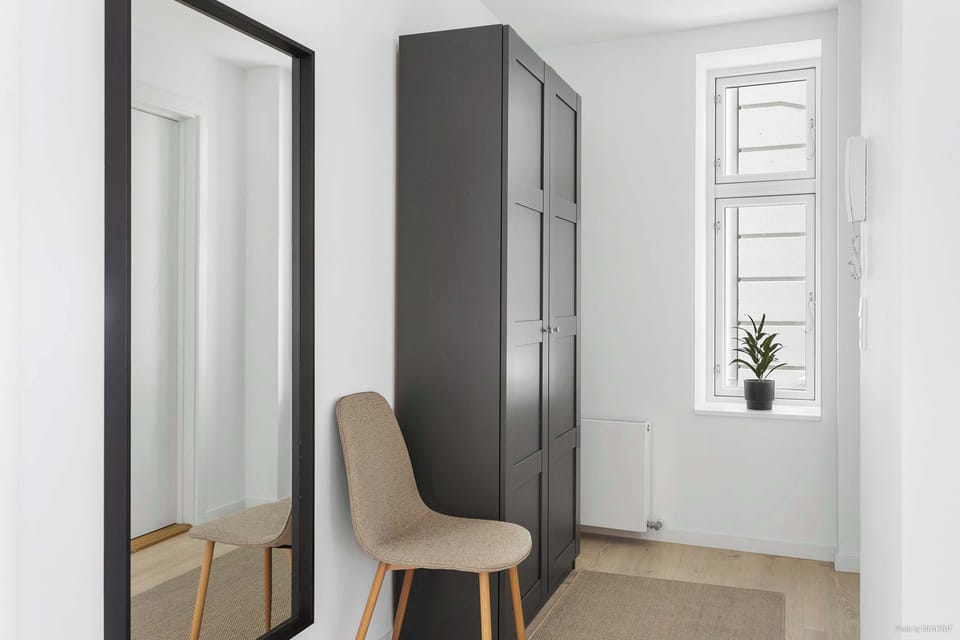 Entrance with full-size mirror and large closet for jackets and more.