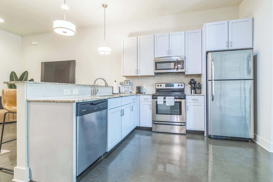 The chic, open kitchen offers ample space & every home comfort