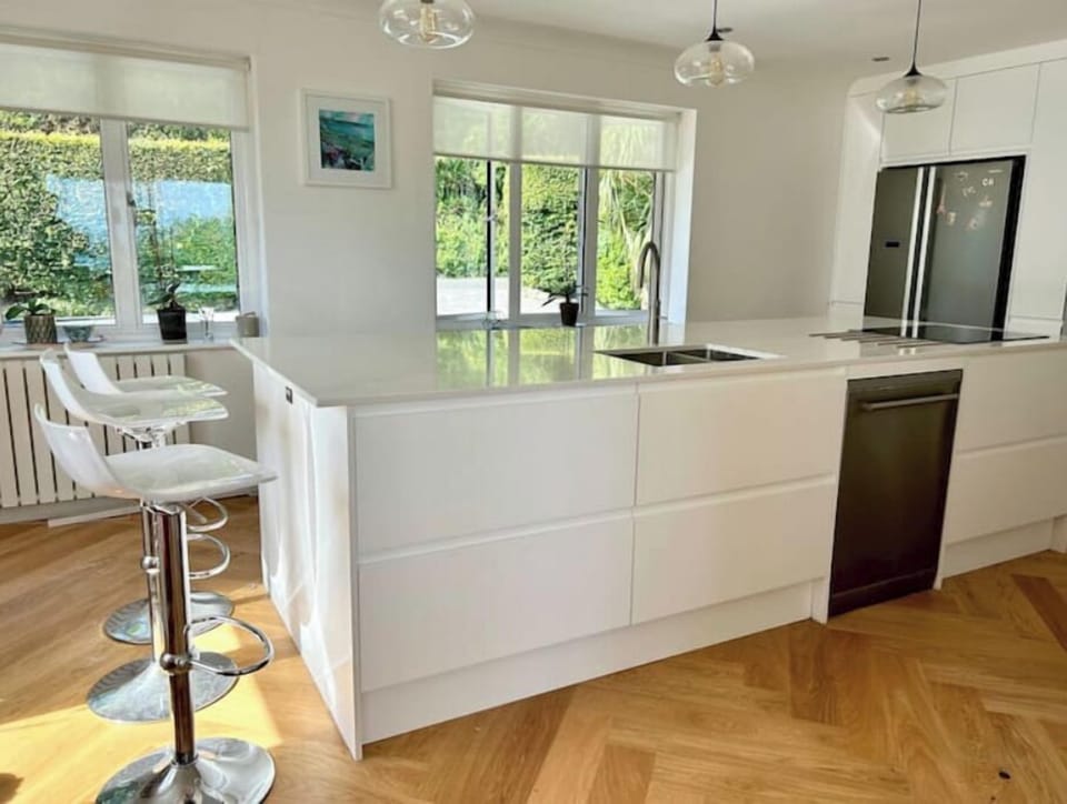 Well equipped Island kitchen with oak herringbone flooring 