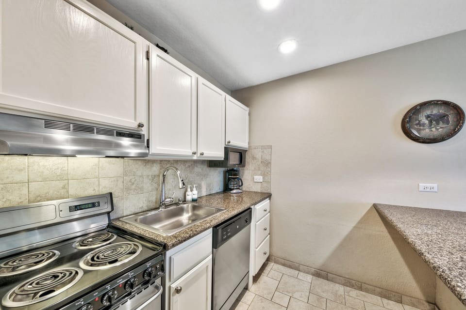 Your fully equipped kitchen awaits with granite counters, stainless appliances, and everything needed to create memorable meals during your stay.