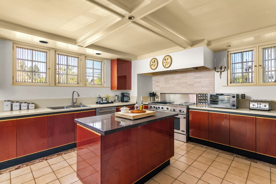 Expansive chef’s kitchen with island and stainless appliances.