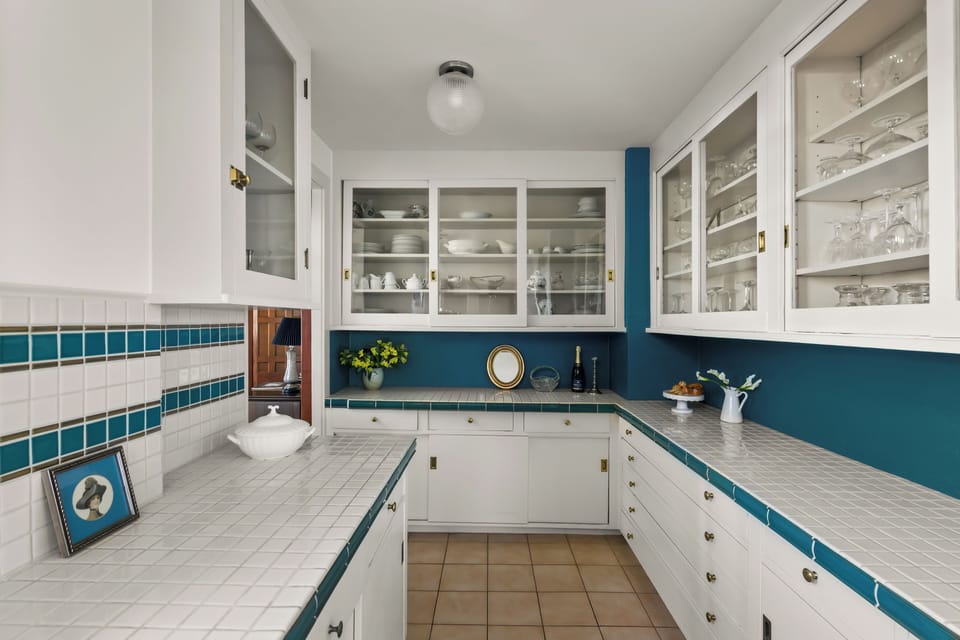 Butler’s pantry with vintage tile and open shelving.