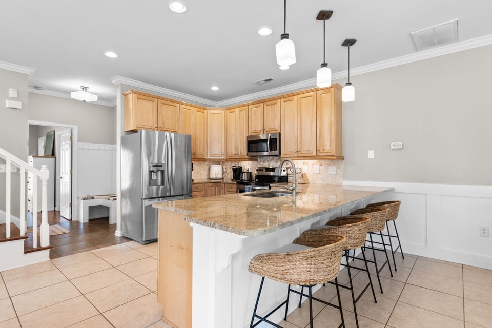 Your spacious kitchen features granite countertops, stainless steel appliances, and a breakfast bar where you can enjoy morning coffee together.