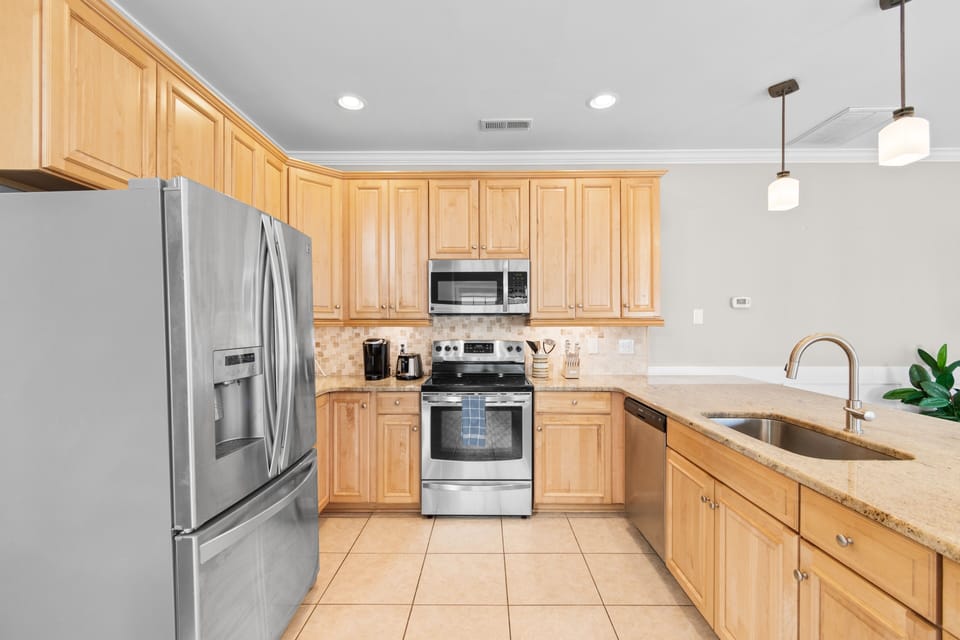 Your fully equipped kitchen features warm wood cabinets, granite counters, and stainless steel appliances for effortless meal prep.