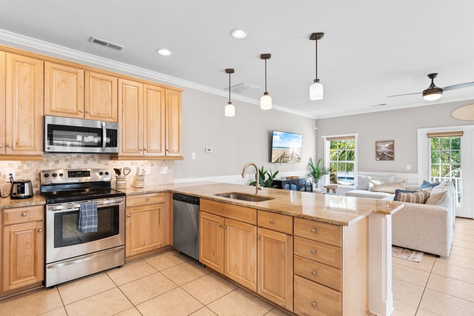 Your spacious open kitchen flows into the living area, creating the perfect space for cooking and entertaining together.