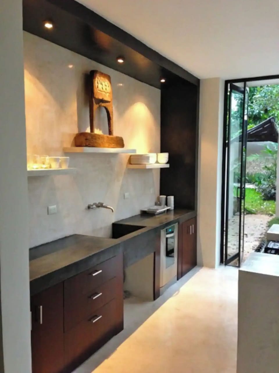 Kitchen with two grills outside glass doors, one gas, one charcoal 