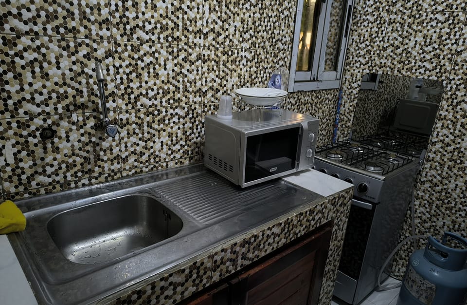 Mini-fridge, microwave, oven, cookware/dishes/utensils