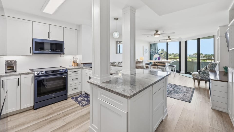 Open-concept kitchen and living area with floor-to-ceiling windows offering great views of the waterfront.