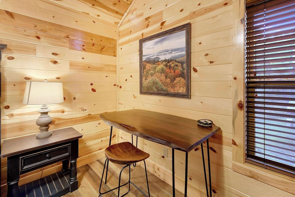 rustic wooden desk and chair set in a cozy corner with natural light from window blinds