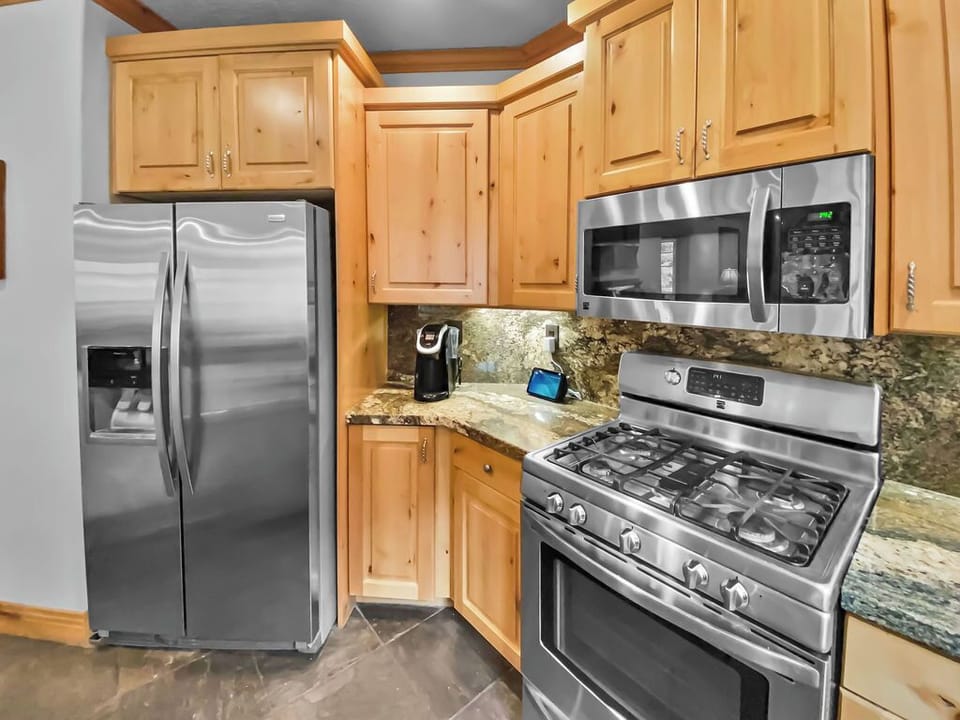 Fully-equipped kitchen with granite countertops and stainless steel appliances. A perfect space for preparing delicious meals during your stay.