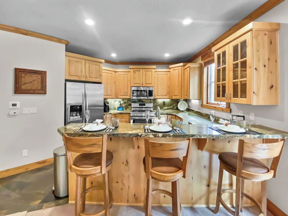 Fully-equipped kitchen with granite countertops and stainless steel appliances. A perfect space for preparing delicious meals during your stay.