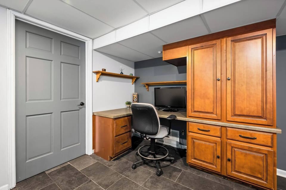 The lower level workspace includes a built in desk and monitor.