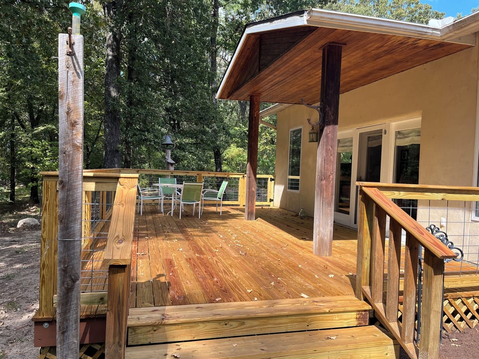 Large deck overlooking woods and our lake. Access from sunroom or driveway.