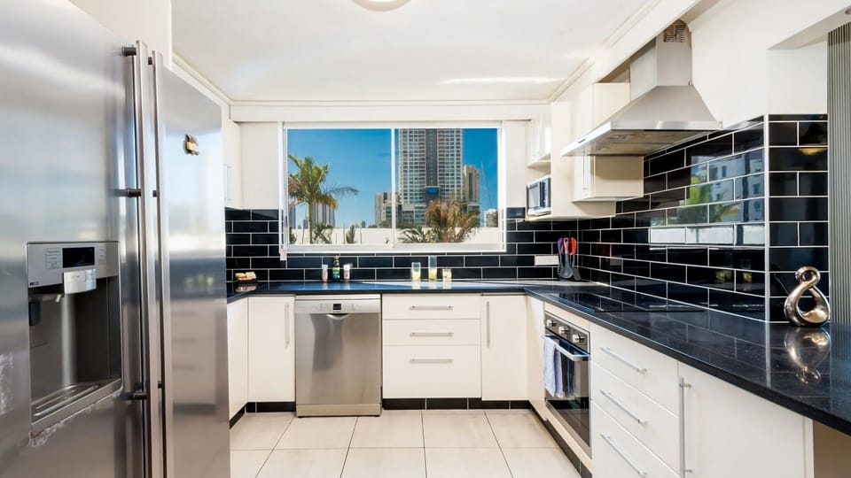 A chef's delight—fully equipped modern kitchen with stainless steel appliances and a spacious dining area.