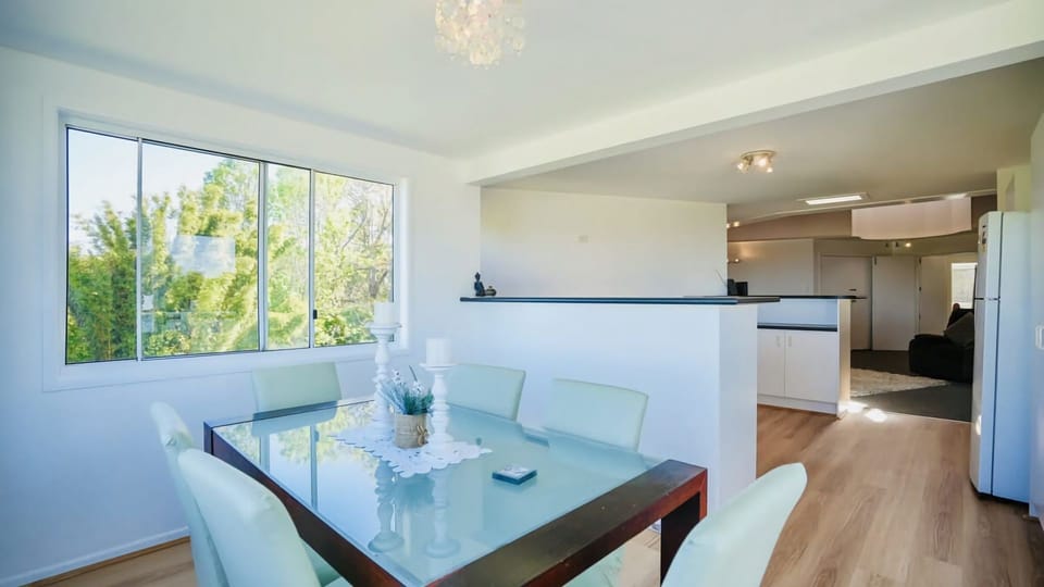 The dining set features a modern table with a glass top and six chairs, comfortably accommodating six people.
