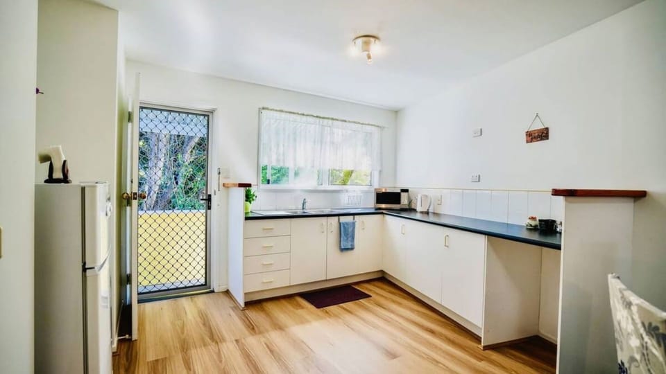 A secondary kitchen space or utility area with direct outdoor access