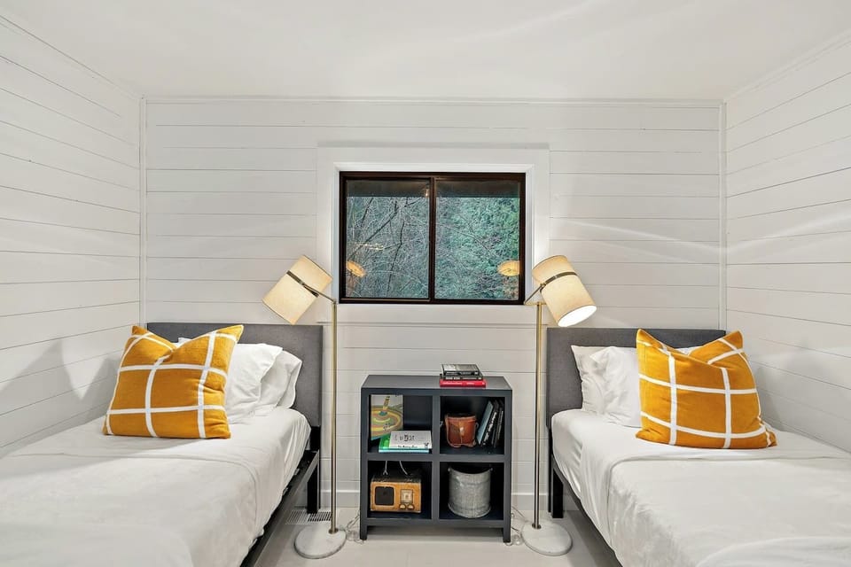 A closer look at the twin room, where thoughtful decor meets natural light and redwood views.