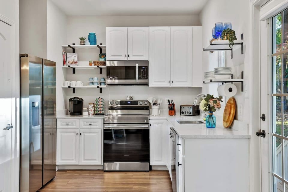 Fully functional kitchen with cookware, baking dishes, blender, crockpot, electric tea kettle, toaster, spices, hand mixer, mixing bowls, and  measuring spoons and cups. 