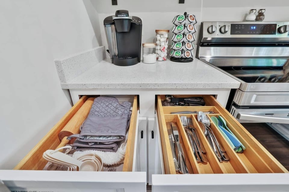 Coffee bar with all the essentials. Measuring cups and spoons, kid's silverware, rolling pin, wine screw, and can opener.