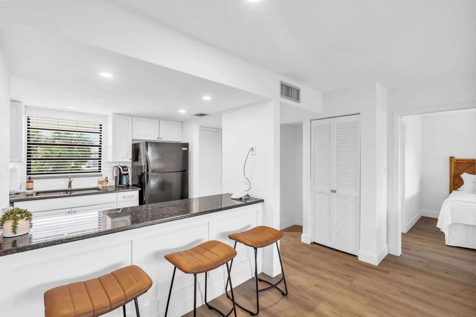A view of the large and open kitchen that opens to the casual bar stools 