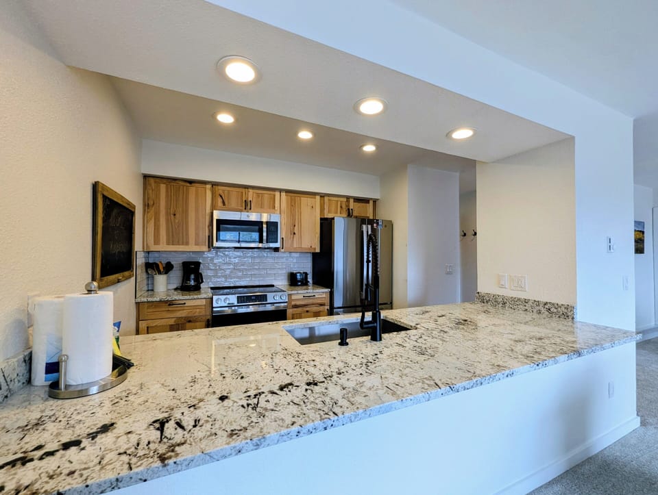 Updated bright kitchen with stainless appliances