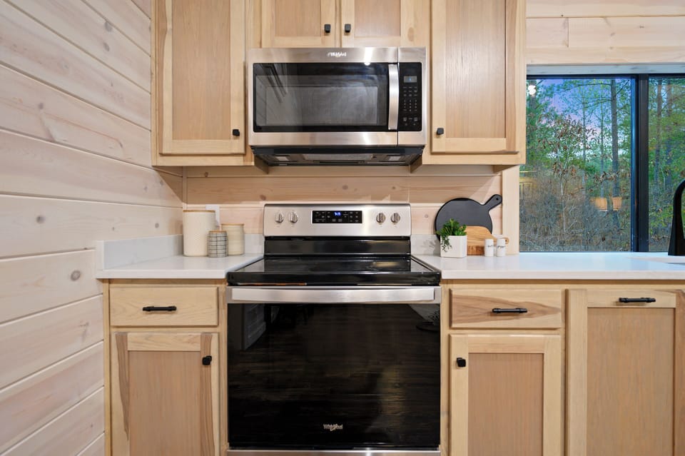 Cook up something special while enjoying a view of the surrounding woods through the large kitchen window.