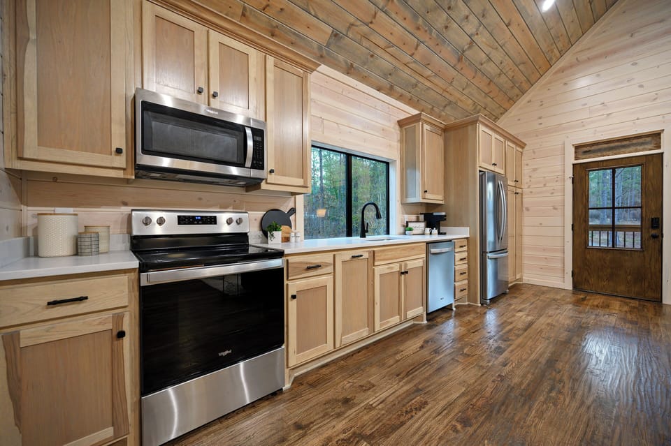 The modern kitchen offers all the amenities you need for a perfect stay, including stainless steel appliances and plenty of counter space.