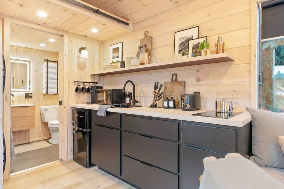 The fully equipped kitchen makes meal preparation a breeze, and the dining area provides a perfect spot to enjoy your creations. 