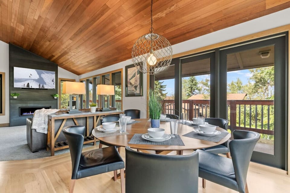 Open-concept dining and living area, perfect for relaxing by the fire and enjoying meals with stunning mountain views.