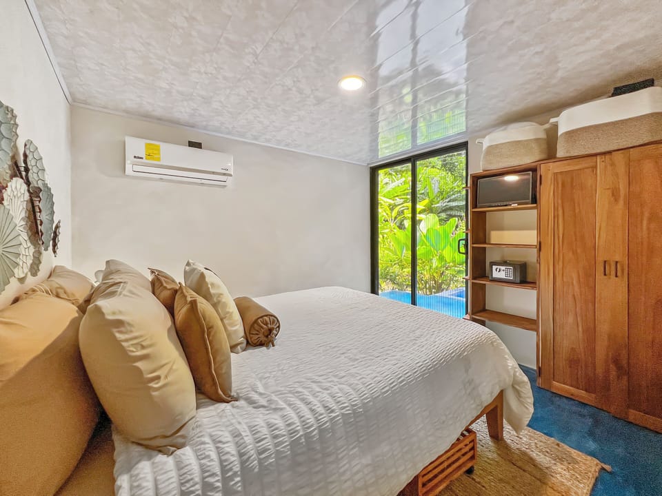 Bedroom has mini tv, safe, closet and under bed storage