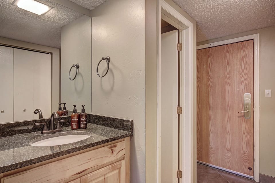 Extra sink/vanity outside of bathroom, in hallway.