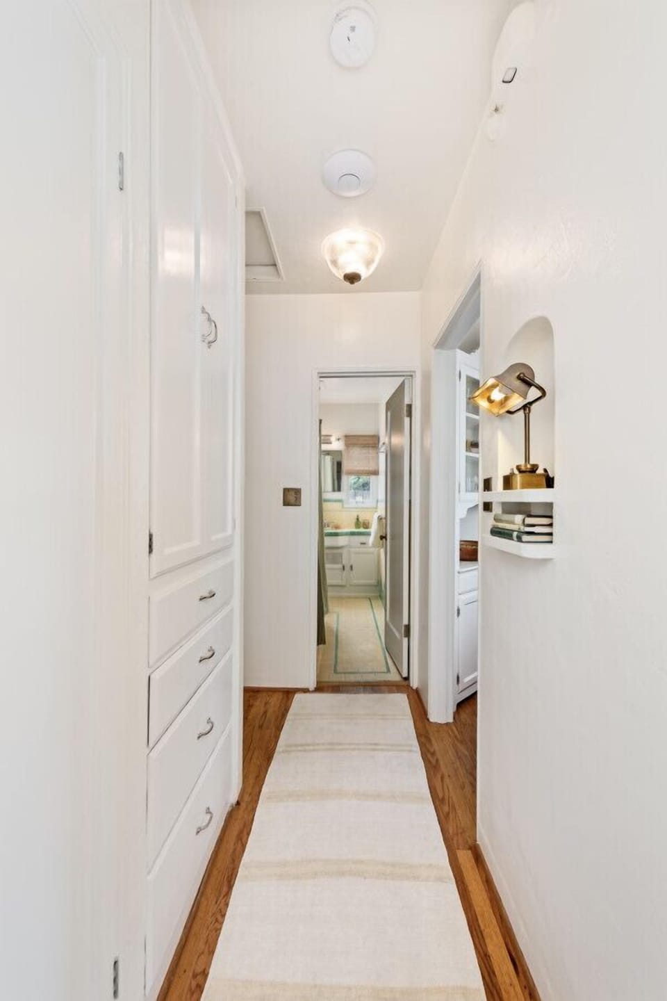 The hallway leads to the bathroom for an easy access from the bedroom.