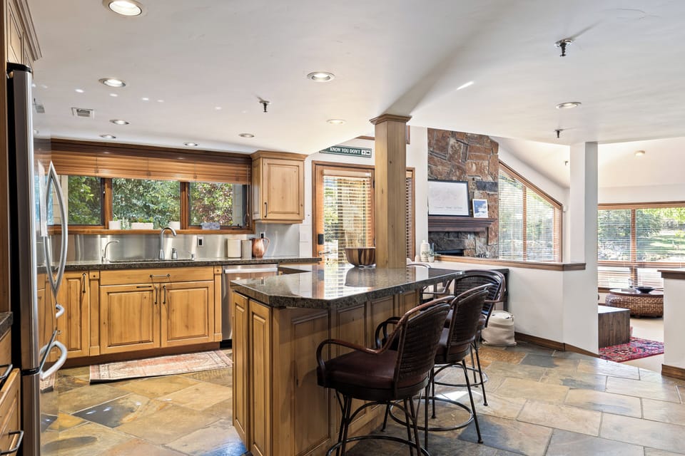 - Open kitchen with breakfast bar and lodge inspired style  
- Natural wood cabinetry and stainless steel appliances  
- Bright space connected to living room for easy gatherings