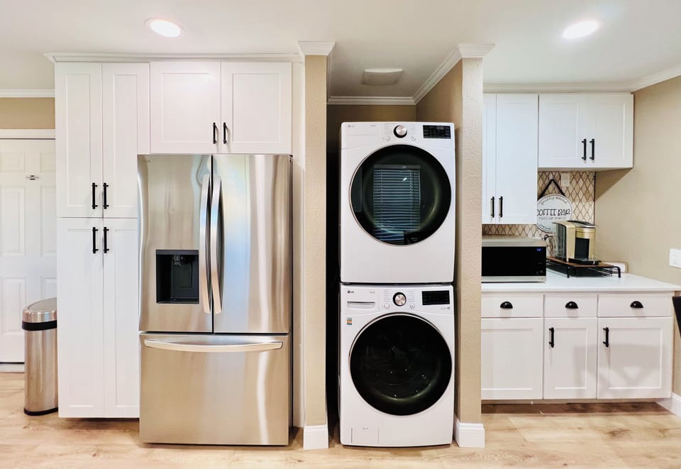 Full kitchen with fridge and full-size washer and dryer