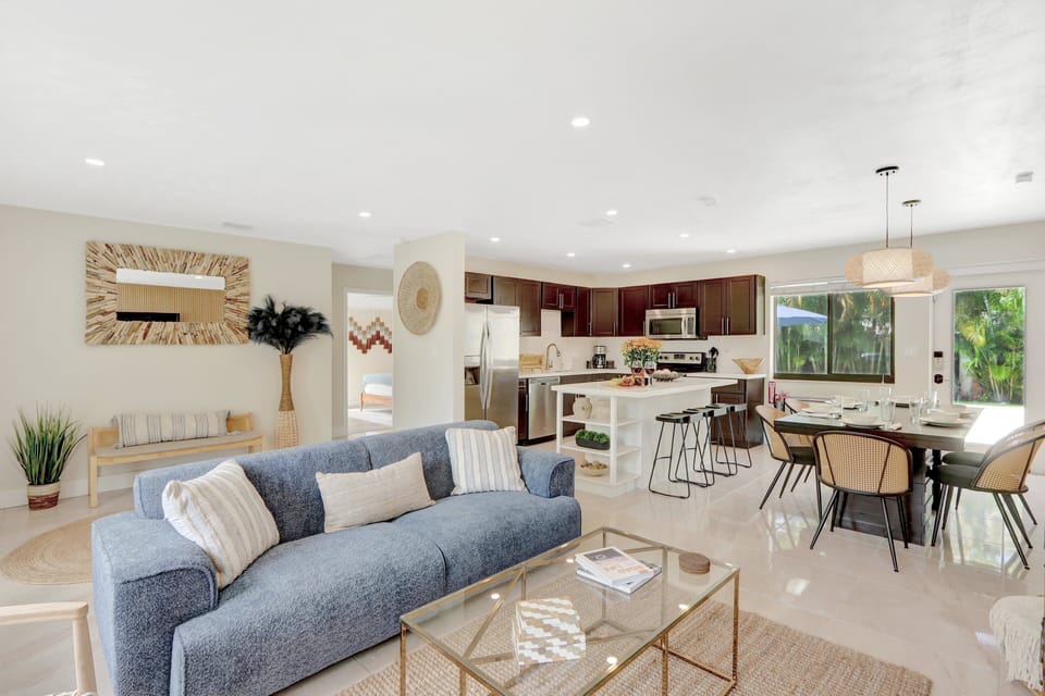 Living Room | Lends a warm welcome + offers an open concept layout into dining and kitchen areas.