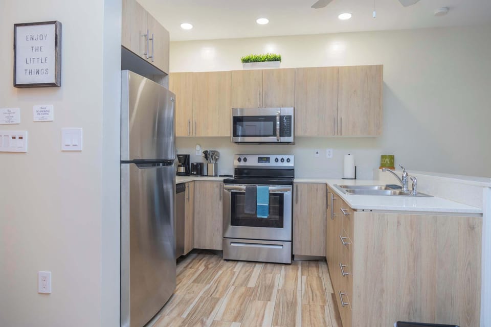 A sleek, modern kitchen with stainless steel appliances and clean, neutral finishes.
