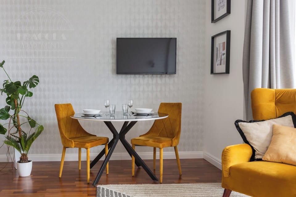 Deluxe Studio Suite, Balcony, City View | Living area | TV