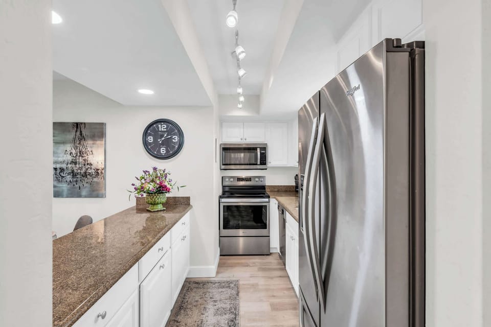 The kitchen includes a suite of stainless steel appliances 
