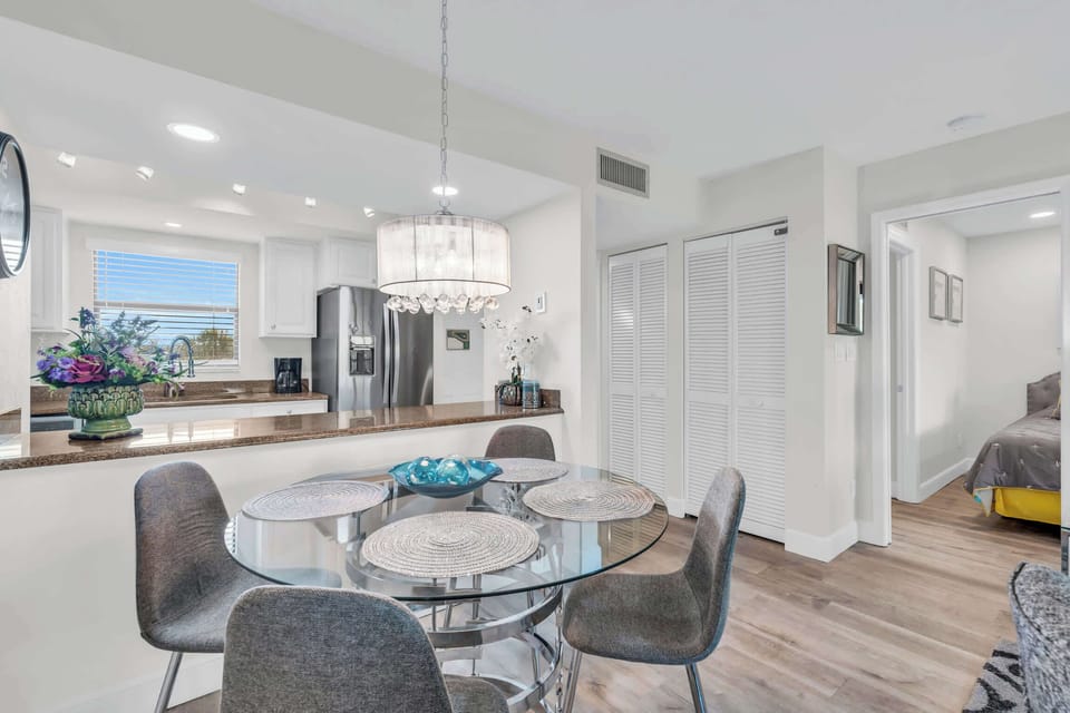 The kitchen has an open counter to the dining set that seats 4 