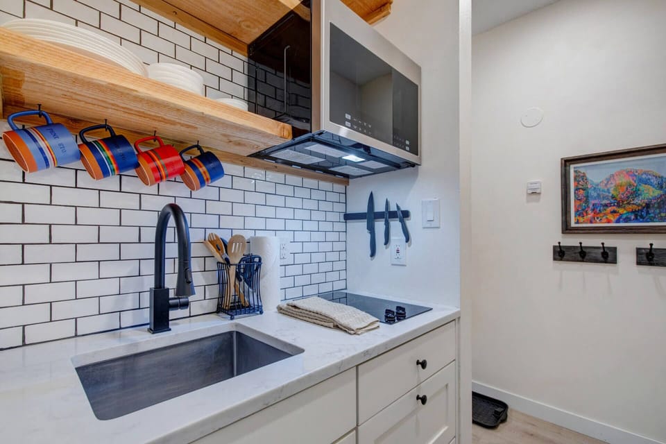 Your kitchenette features crisp subway tile, sleek countertops, and everything you need to whip up meals—from stainless steel sink to modern microwave.
