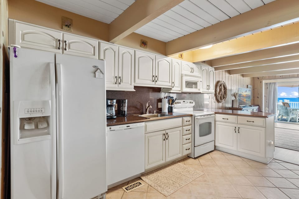 With Gleaming Countertops, Stainless Appliances.