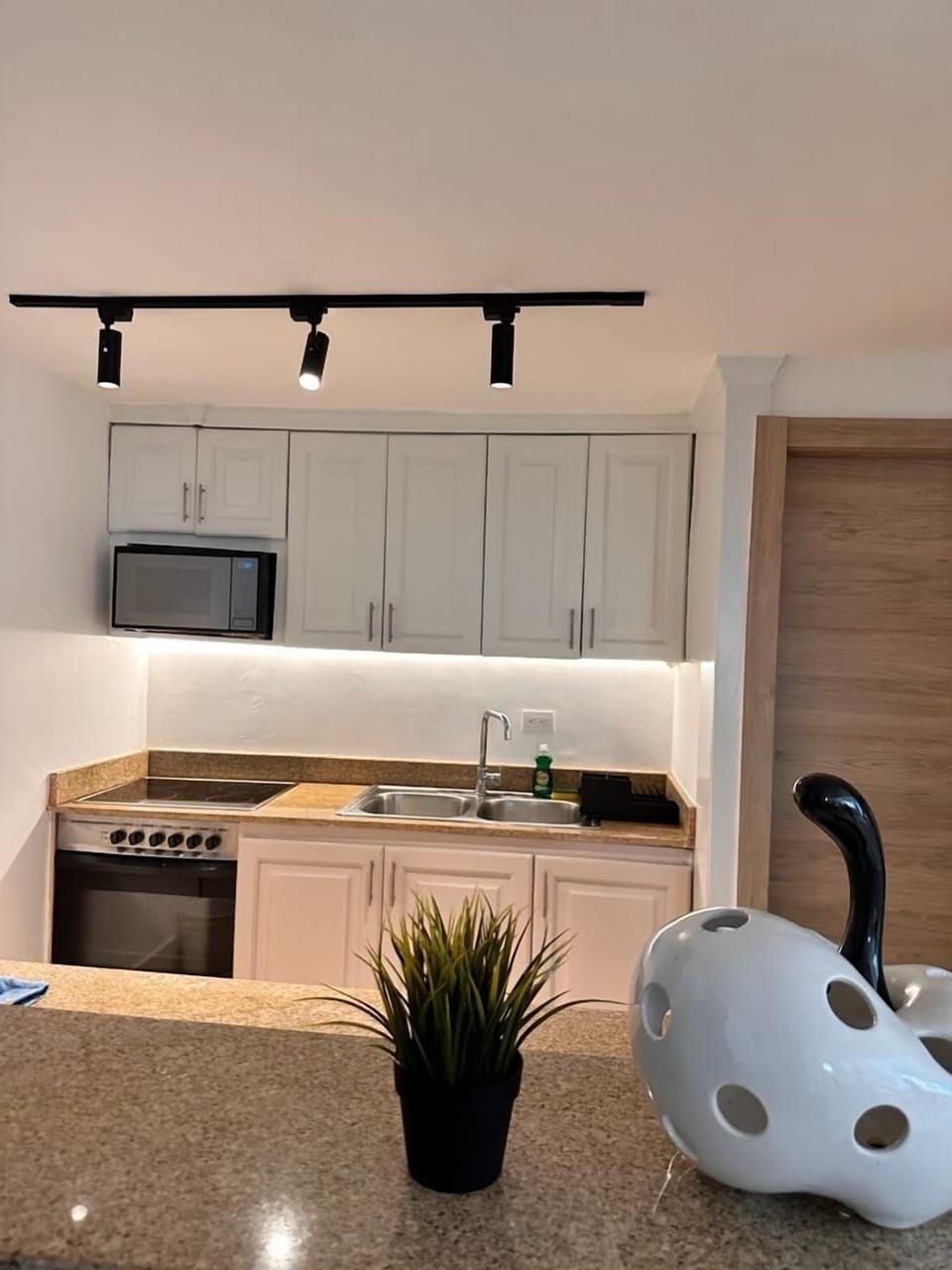 The modern kitchen has everything needed to cook and serve delicious meals