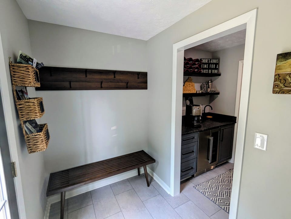 Coat hook & bench area next to butler's pantry.