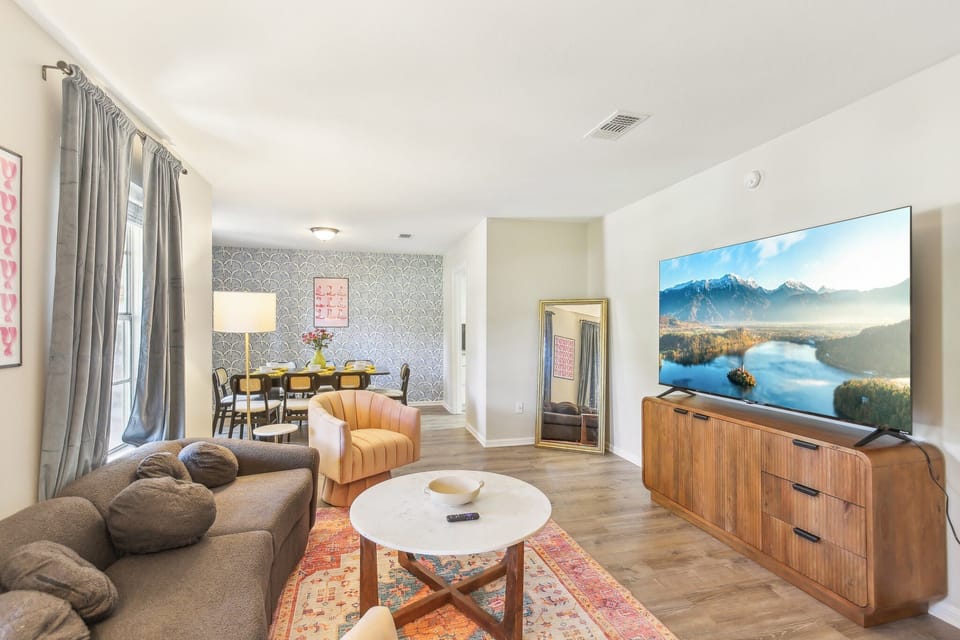 Cozy, vibrant living room to gather with friends and family to watch on the 75"!