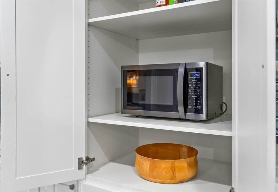 A peek into the pantry, complete with a convenient microwave and lots of storage for all your snacks and essentials.
