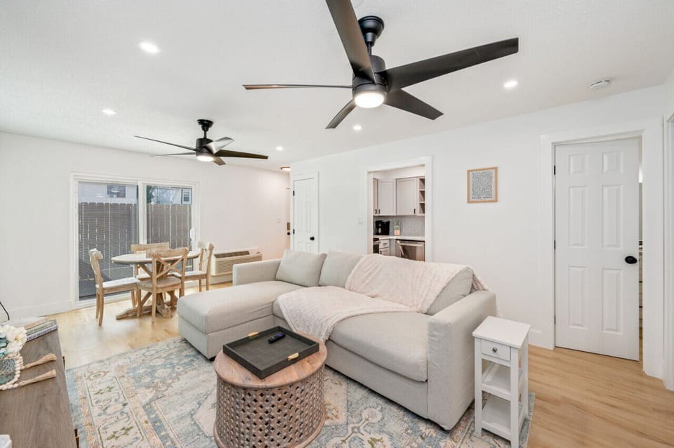 Open plan layout with dining, lounge, and natural light throughout.