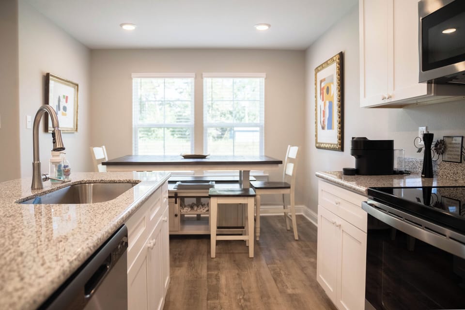 Open kitchen with dining table and island seating 