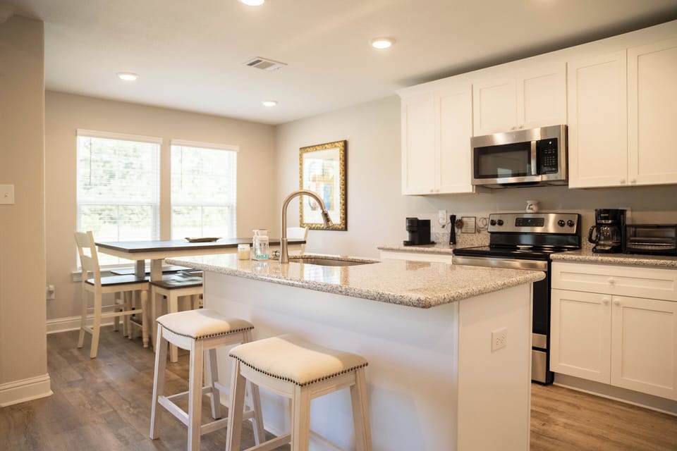 Open kitchen with dining table and island seating 